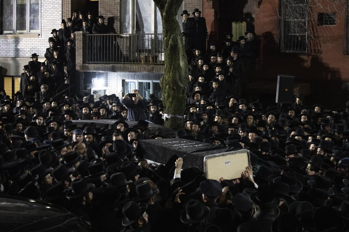 Orthodox Jews carry Moshe Deutsch's casket outside a Brooklyn synagogue following his funeral Wednesday. Deutsch was killed Tuesday in a shooting inside a Jersey City, N.J., kosher food market.