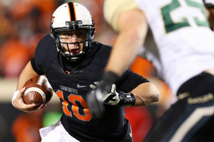 Oklahoma State quarterback Clint Chelf passed for three touchdowns and rushed for another Saturday during the Cowboys' 49-17 victory over Baylor.