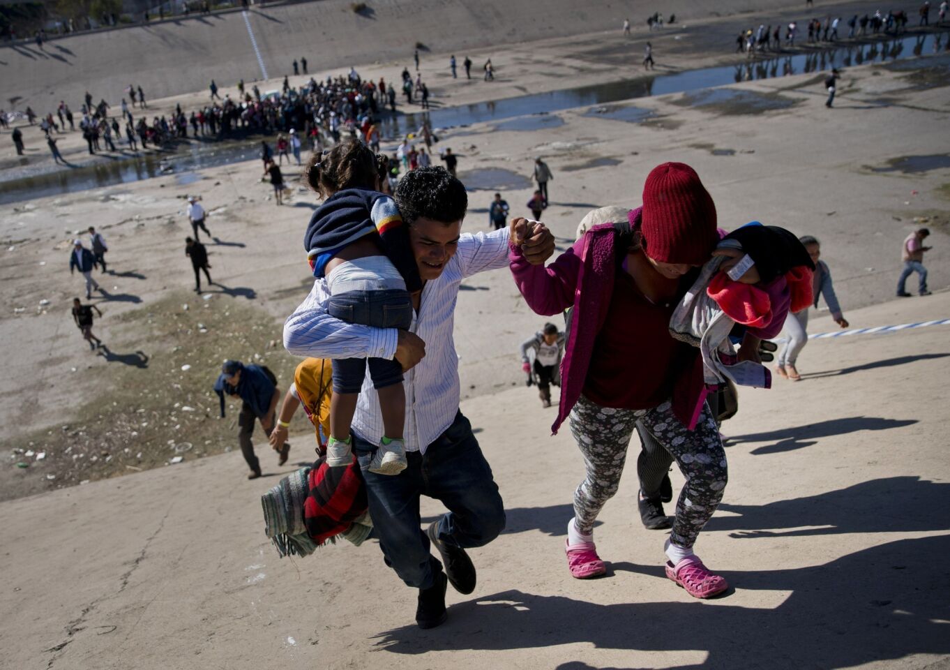 Migrants try to cross border at Tijuana