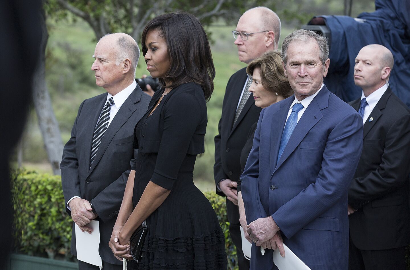 From left, California Gov. Jerry Brown, First Lady Michelle Obama, former First Lady Laura Bush and former President George W. Bush wait to pay their respects at Nancy Reagan's gravesite at the Ronald Reagan Presidential Library in Simi Valley.