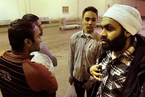 Just after being released from a U.S. immigration detention center, four men from India discuss their next move at the Greyhound bus depot in Harlingen, Texas. They were arrested trying to enter the U.S. from Mexico. Most Indian nationals caught entering cite "credible fear," pleading that if they are deported to their home country they will be persecuted. Most are set free on bonds of $10,000 to $40,000 and the promise to return for a political asylum hearing. Many take buses from here and disappear into the underground labor pool throughout the U.S. Read the full story.