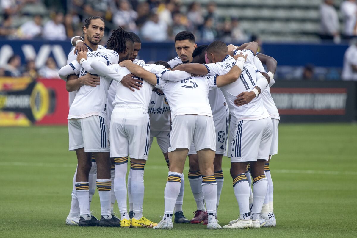Galaxy defender Martin Cáceres peeks out to see the fans before an MLS playoff match against Nashville SC.