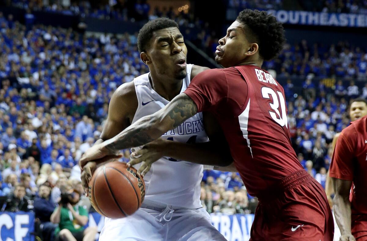 Kentucky center Dakari Johnson tries to drive to the basket against Arkansas guard Anton Beard in the second half Sunday.