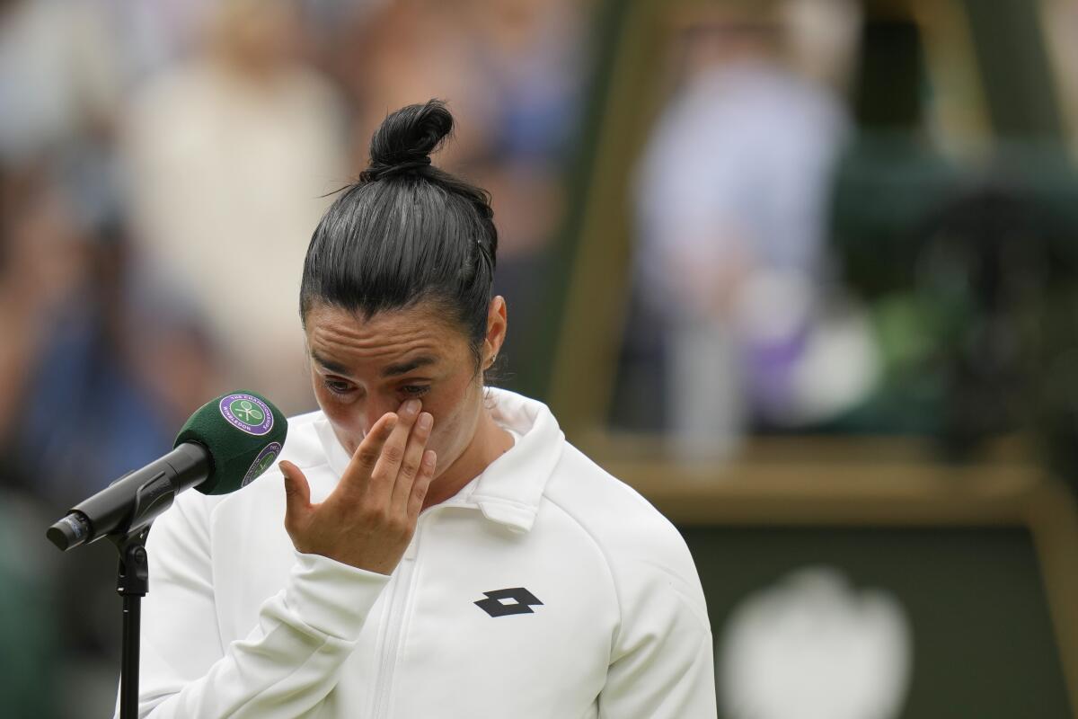 Tunisia's Ons Jabeur wipes away tears while speaking to fans after losing the Wimbledon final 