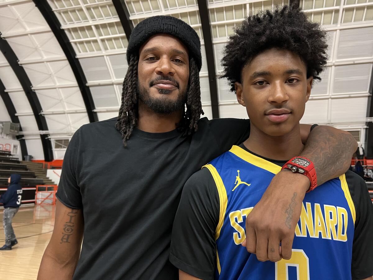 Trevor Ariza and son Tajh pose for a photo.