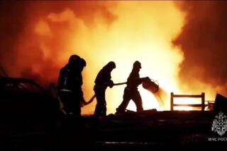In this image made from video provided by the Russian Emergency Situations Ministry press service, firefighters work to extinguish a fire at a petrol station on a road near Makhachkala, the capital of Dagestan, Russia, late Monday, Aug. 14, 2023. (Ministry of Emergency Situations press service via AP)