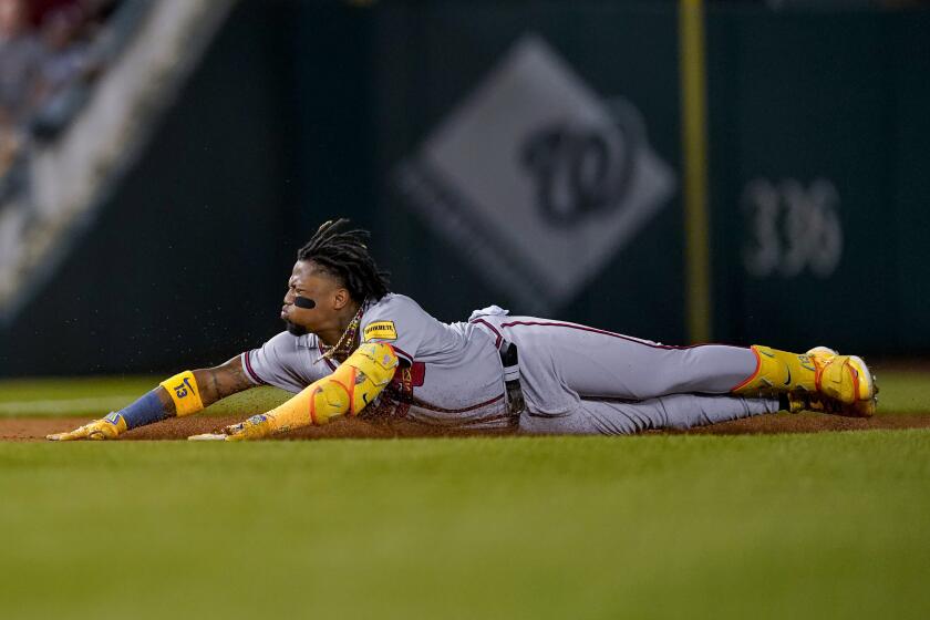 Atlanta Braves' Ronald Acuña Jr. slides into third base on a triple against the Washington Nationals during the third inning of a baseball game at Nationals Park, Thursday, Sept. 21, 2023, in Washington. (AP Photo/Andrew Harnik)