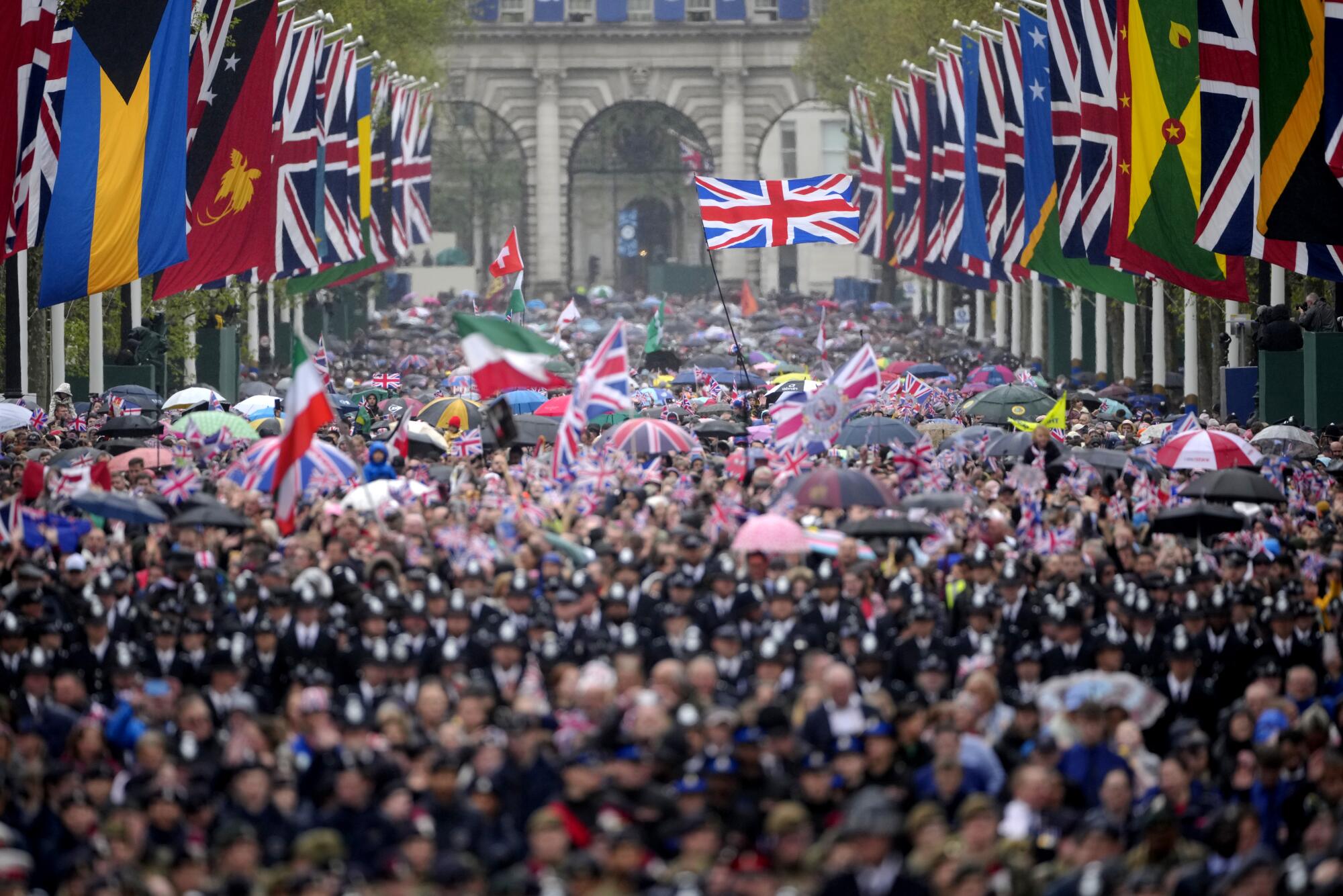 Crowds walk toward Buckingham Palace. 