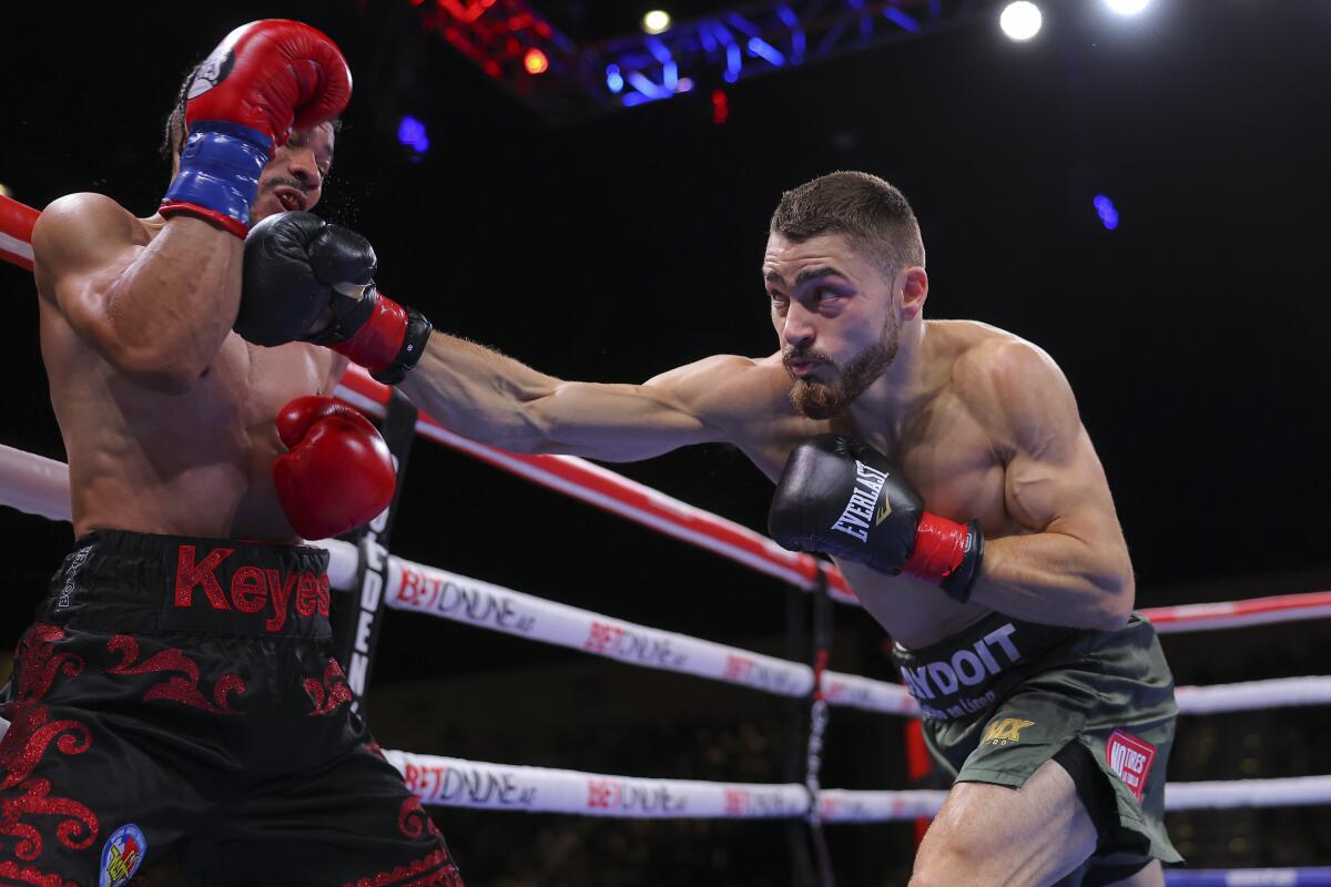 Oscar Duarte, right, throws a punch against D'angelo Keyes at Santa Fe Springs Special Events Center on May 27