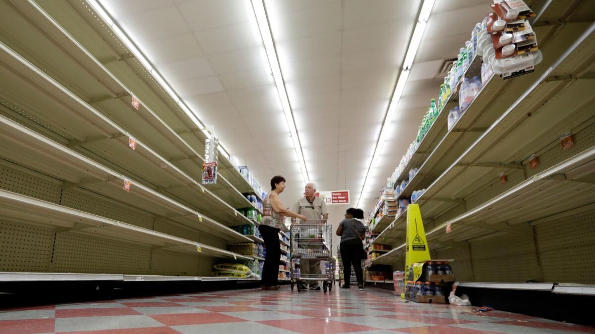 The bottled water aisle in a Houston grocery store was nearly empty last week as Hurricane Harvey approached. Would price gouging have kept the shelves filled?