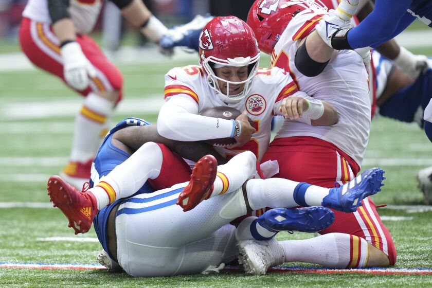 Kansas City Chiefs quarterback Patrick Mahomes (15) is sacked by Indianapolis Colts defensive end Yannick Ngakoue (91) during the first half of an NFL football game, Sunday, Sept. 25, 2022, in Indianapolis. (AP Photo/AJ Mast)