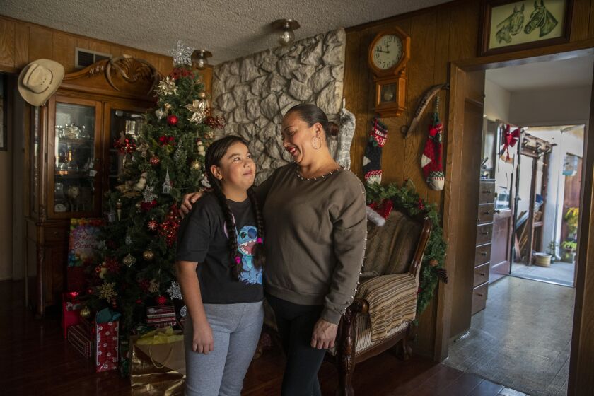 HAWTHORNE, CA - December 13: Rosa Vasquez and her daughter Xitlali, 9, who developed MIS-C in May. After arriving at Children's Hospital Los Angeles, Xitali's heart momentarily stopped. She recovered days later, but is still seeing longterm effects from the illness. Photo taken at their home in Hawthorne, Sunday, Dec. 13, 2020. (Allen J. Schaben / Los Angeles Times)