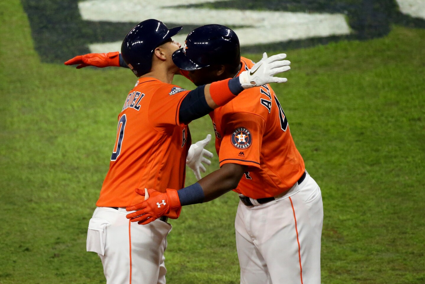 HOUSTON, TX - OCTOBER 30: Yuli Gurriel #10 of the Houston Astros is greeted by teammate Yordan Alvarez #44 after hitting a solo home run in the second inning during Game 7 of the 2019 World Series between the Washington Nationals and the Houston Astros at Minute Maid Park on Wednesday, October 30, 2019 in Houston, Texas. (Photo by Cooper Neill/MLB Photos via Getty Images)