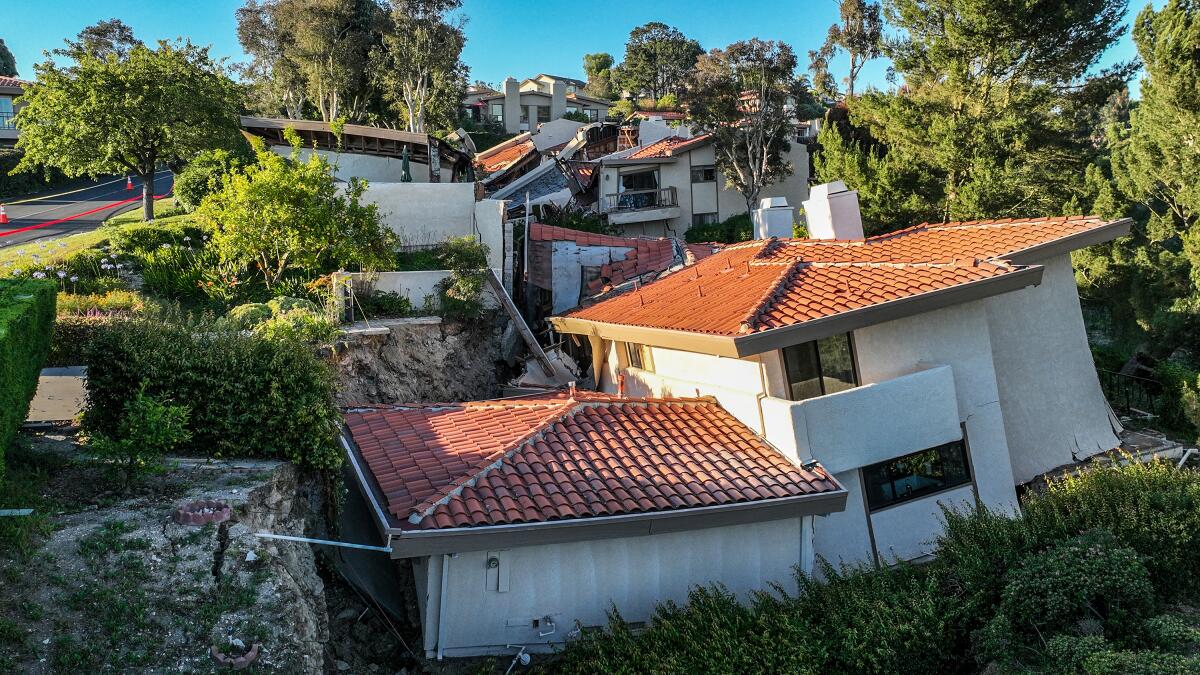 Homes with red tile roofs have collapsed.