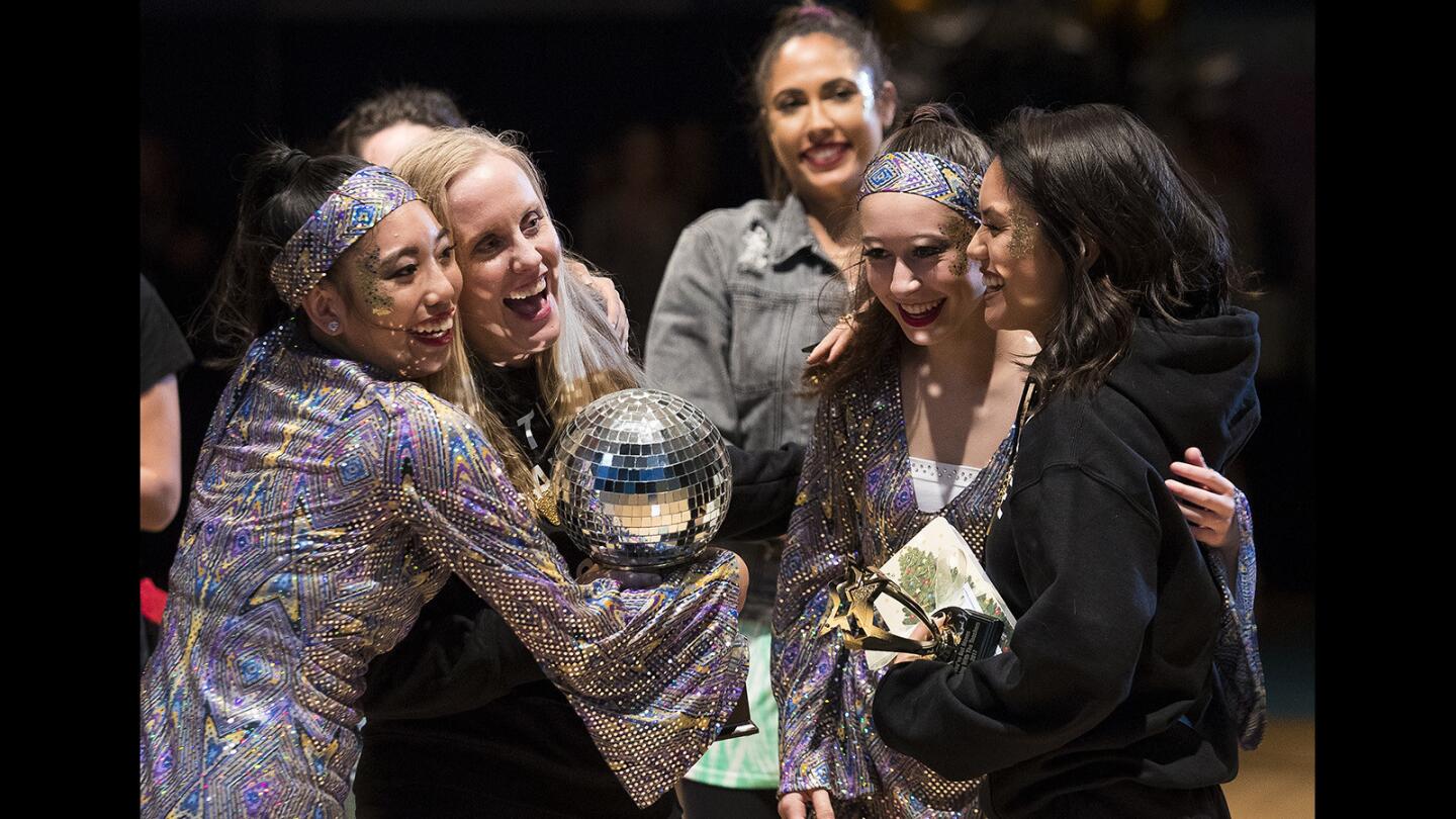 The team of Angelina Carpio, Heather Kroeger, Madison Lobel and Jessica Abulencia, from left, celebrates winning the judges' award during the Dancing with the Teachers event at Corona del Mar High School on Thursday night. Carpio and Lobel are members of the school dance team Orchesis. Kroeger and Abulencia are science teachers.