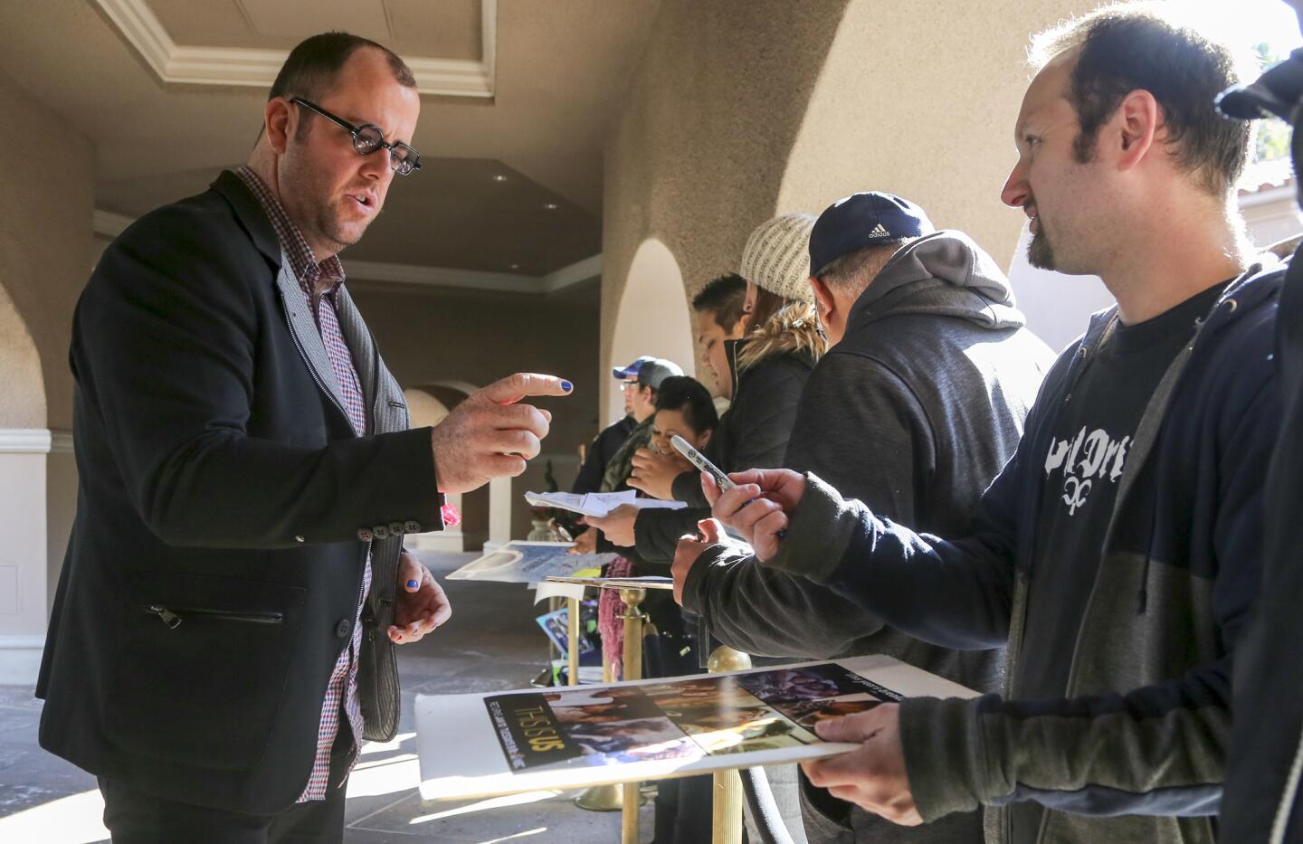 Actor Chris Sullivan of NBC's "This Is Us" signs autographs near the entrance to the Langham Huntington Hotel in Pasadena on Jan. 18. Autograph hunters, or "graphers," hope for a chance meeting with celebrities coming and going from the Television Critics Assn.'s winter press tour.