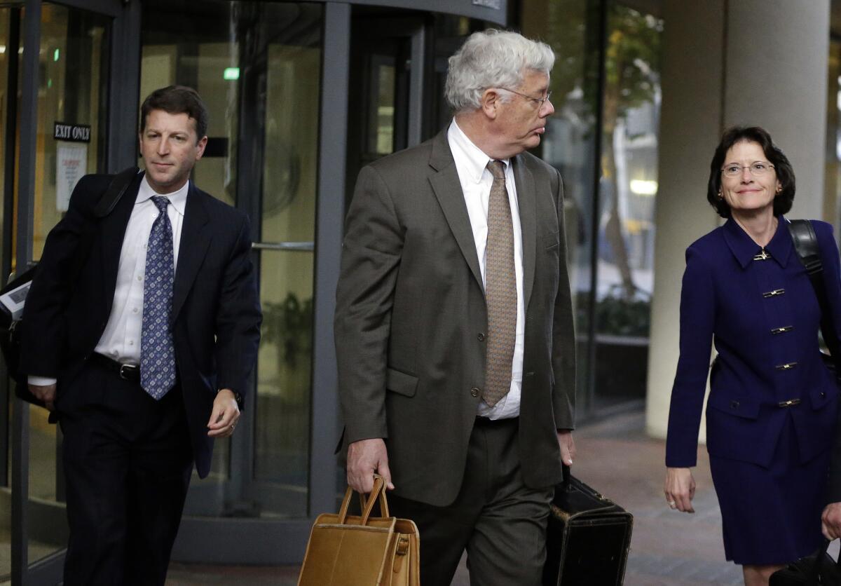 Harold McIlhenny, center, an attorney representing Apple Inc. in the Apple-Samsung trial, exits a federal courthouse in San Jose.