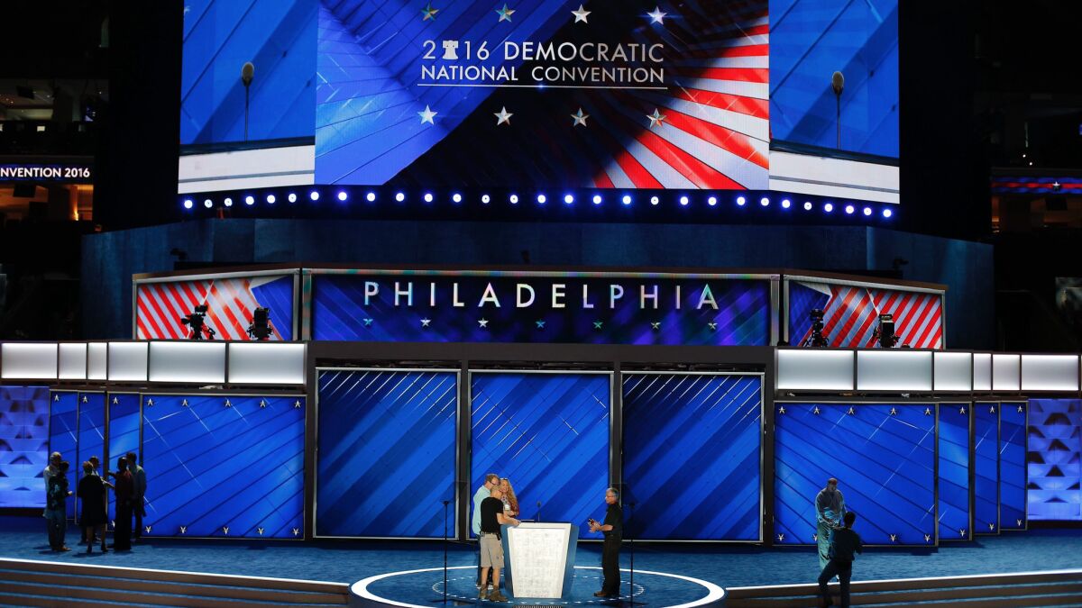 Workers put final touches on the podium as preparations are made for the Democratic National Convention, at the Wells Fargo Center in Philadelphia, Pennsylvania.