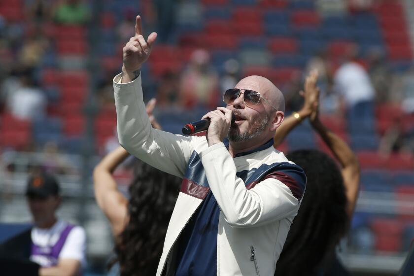 FILE - Pitbull performs prior to a NASCAR Cup Series auto race at Phoenix Raceway in Avondale Ariz., in this Sunday, March 8, 2020, file photo. New NASCAR team Trackhouse Racing has brought entertainer Pitbull on as an ownership partner for an organization making its debut next month at the Daytona 500. “Mr. Worldwide” joins NBA Hall of Famer Michael Jordan as celebrity owners entering NASCAR this year. (AP Photo/Ralph Freso, File)