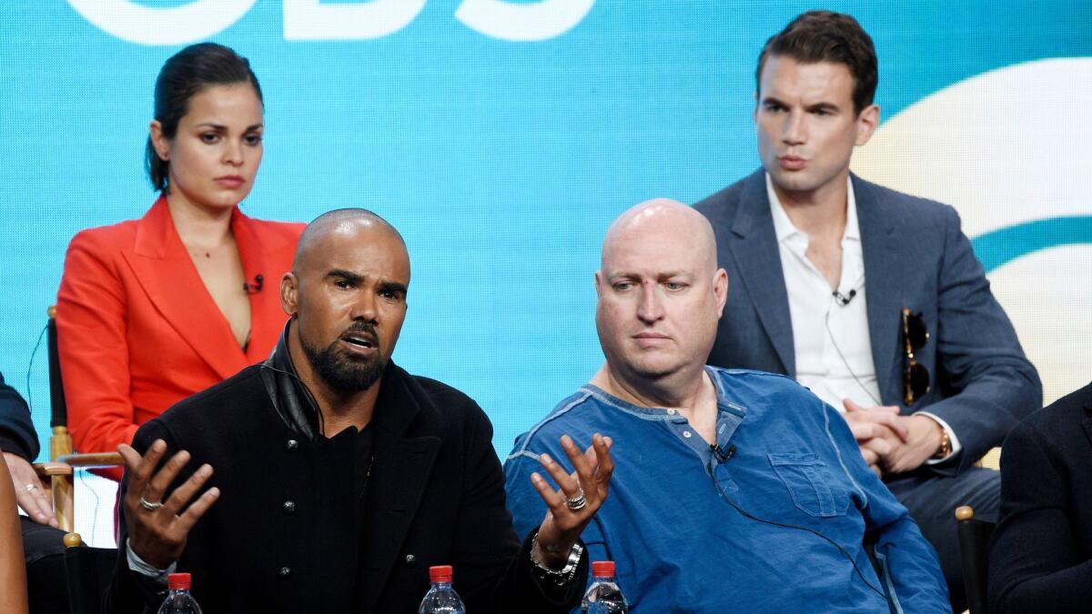 Shemar Moore, left, a cast member in the CBS series "S.W.A.T.," answers a reporter's question during the 2017 Television Critics Association Summer Press Tour.