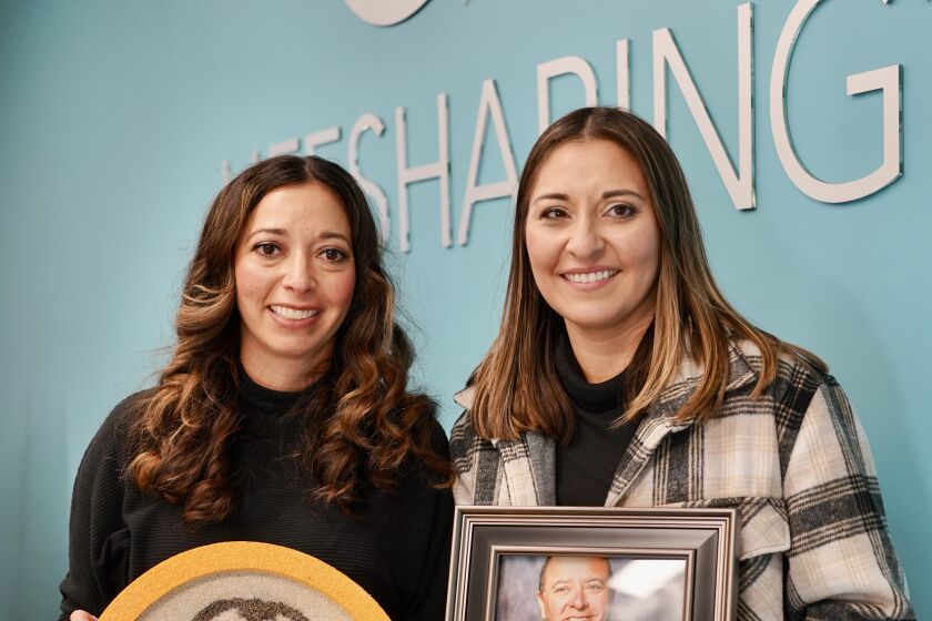 Monique Pascucci and Nadia Powell, two of San Diego Fire-Rescue Capt. Robin Cervantes’ daughters. Monique (L) is holding the floral portrait that was featured on the 2023 Donate Life Rose Parade Float.