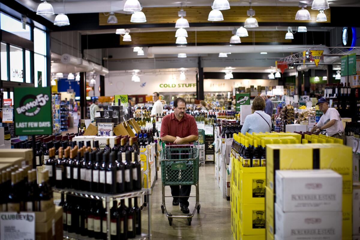 Customers browse the wine section of a BevMo store in Walnut Creek, Calif.