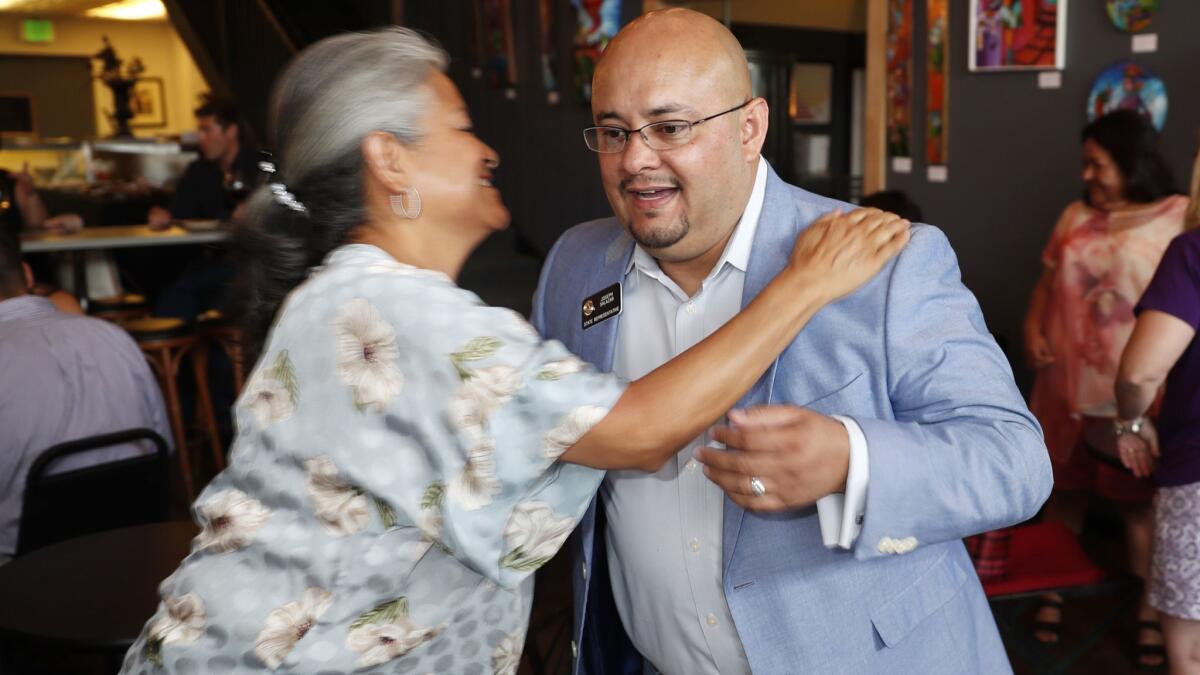 Joe Salazar, one of two Democrats seeking the party's nomination to run for attorney general in Colorado, greets a supporter during a fundraising event in Denver on May 24, 2018.