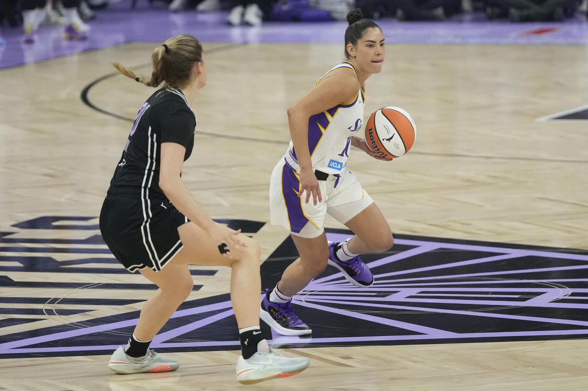 parks guard Kelsey Plum, right, brings the ball up the court while defended by Valkyries guard Kate Martin.