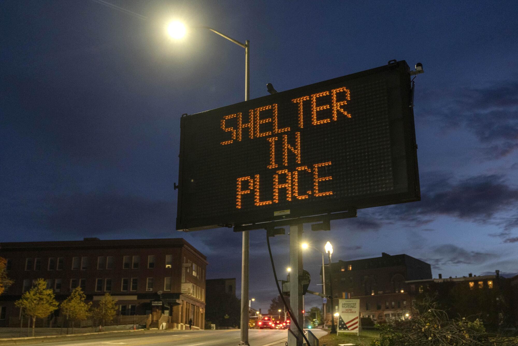 An electronic road sign reads "SHELTER IN PLACE."