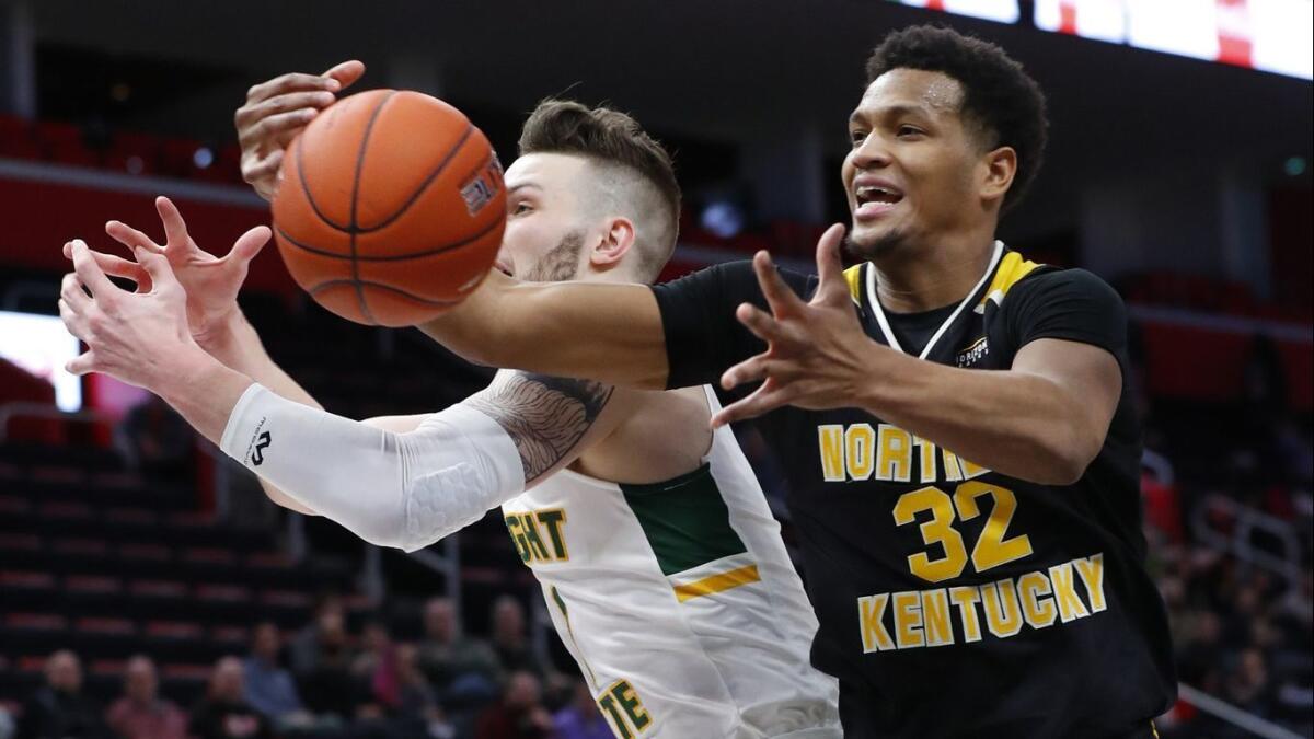Northern Kentucky forward Dantez Walton (32) pulls down a rebound from Wright State forward Billy Wampler (1) in the first half on Tuesday in the Horizon League conference tournament championship in Detroit.