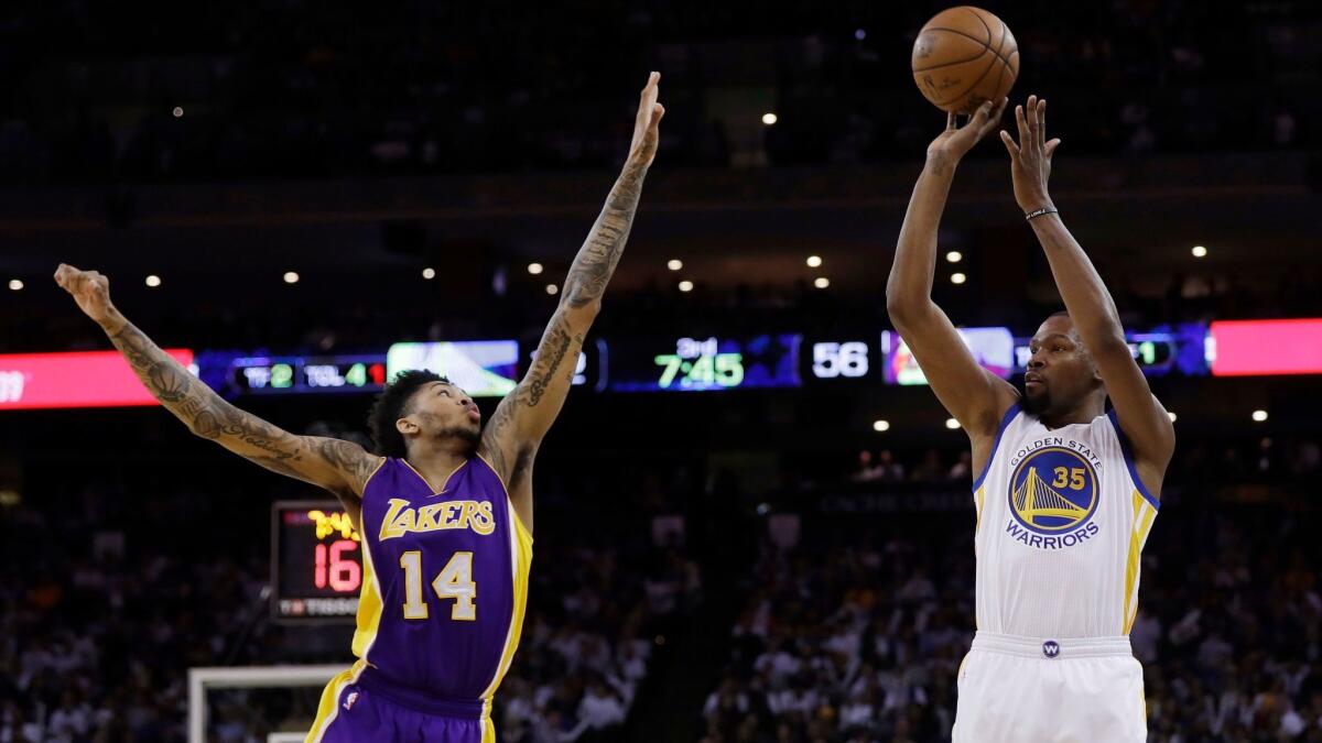 Lakers' Brandon Ingram looks to block a shot by Golden State's Kevin Durant on April 12.