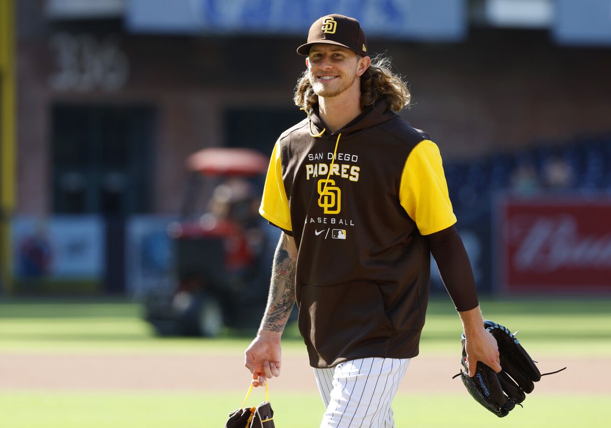Padres pitcher Josh Hader smiles at fans chanting his name after a game against the Colorado Rockies