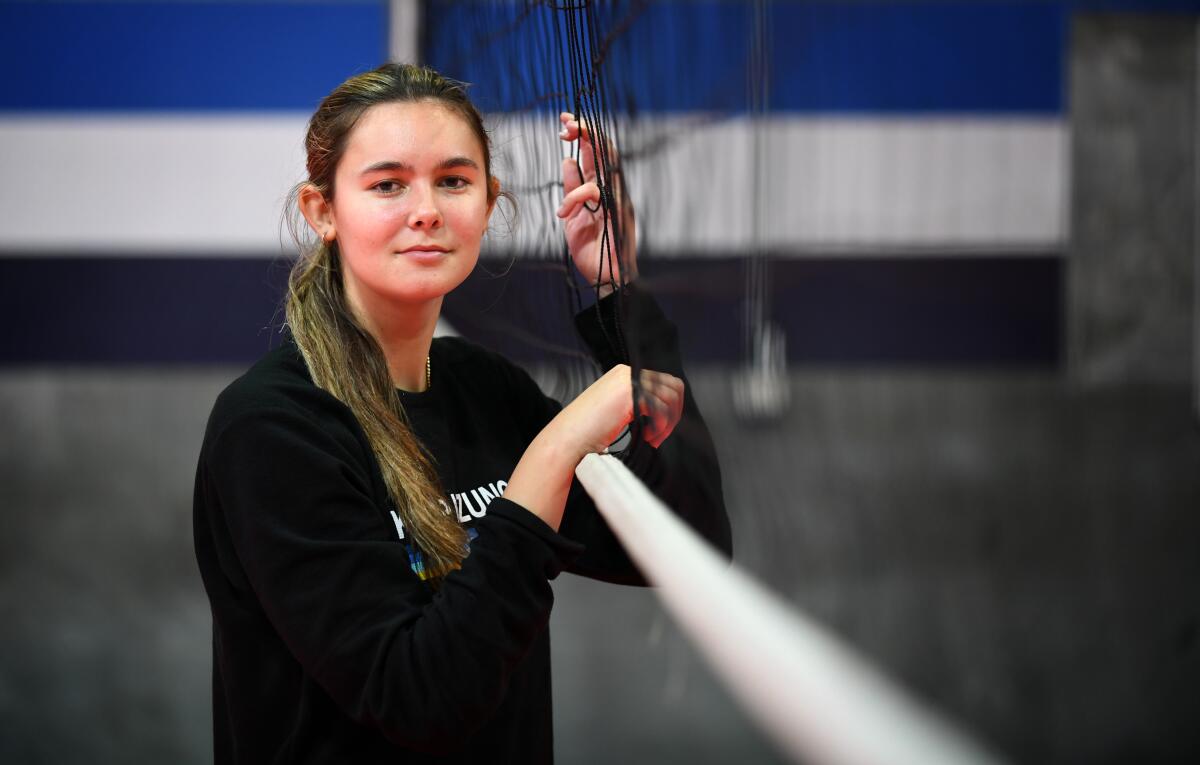 Mira Costa High volleyball star Charlie Fuerbringer poses next to a volleyball net