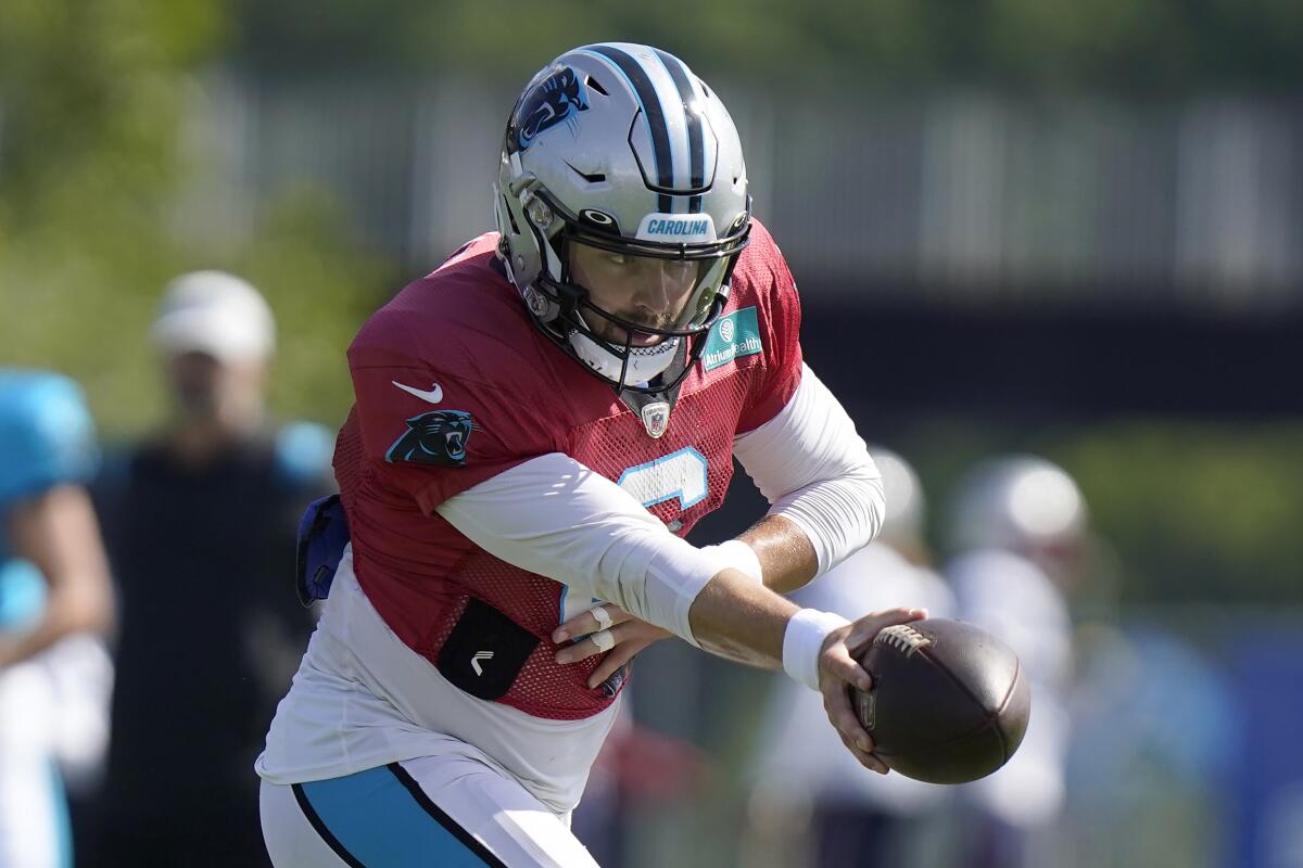 Carolina Panthers quarterback Baker Mayfield prepares to hand off the ball during an NFL football joint practice with the New England Patriots, Tuesday, Aug. 16, 2022, in Foxborough, Mass. (AP Photo/Steven Senne)