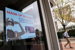 Signs indicating that protective face masks must be worn in classrooms are displayed outside lecture halls at Columbia University, Thursday, April 21, 2022, in the Manhattan borough of New York. (AP Photo/John Minchillo)