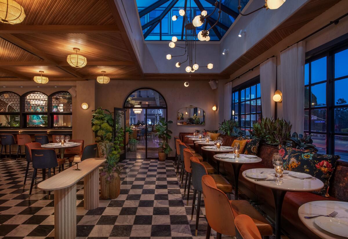 A dining room at Lavo Ristorante features black-and-white checkered floors and red velvet chairs.