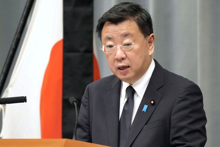 Japan's Chief Cabinet Secretary Hirokazu Matsuno speaks at a press conference in Tokyo Tuesday, Sept. 27, 2022. Japan protested to Russia on Tuesday over a detention of a Japanese consulate official over espionage allegations, denying the allegations and accusing Russian authorities of abusive interrogation. (Kyodo News via AP)