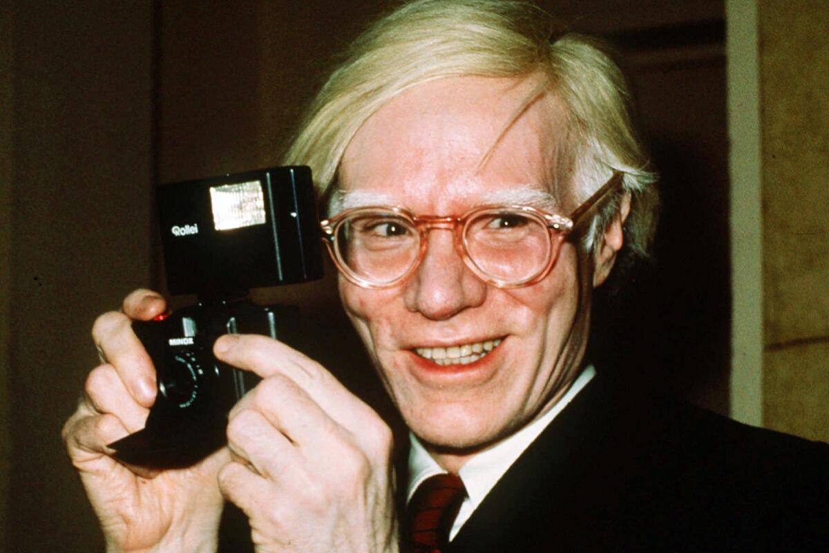 FILE - In this 1976 file photo, pop artist Andy Warhol smiles in New York. Artist Any Warhol and the musician Prince were both center stage Wednesday in a case at the Supreme Court, a copyright case that had the justices discussing topics from Cheerios to the Mona Lisa. (AP Photo/Richard Drew, File)
