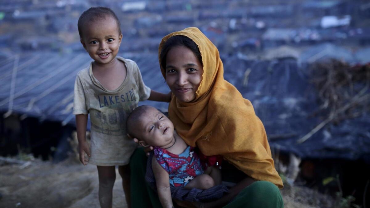 A Rohingya refugee family in front of their makeshift tent at the Balukhali camp in Ukhiya, Bangladesh on Sept. 15.