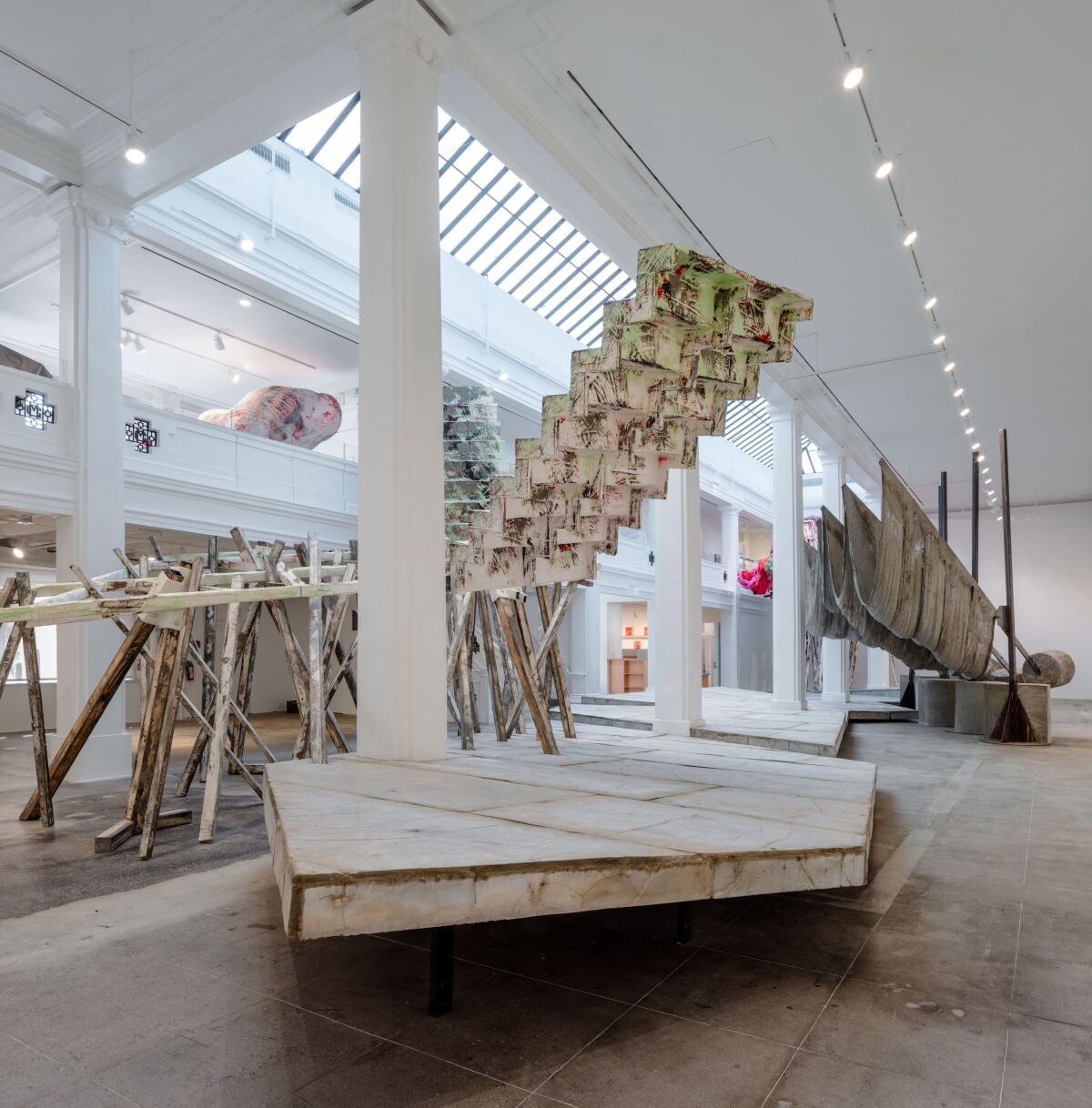 A sculpture that resembles a partial staircase sits in a white gallery space.