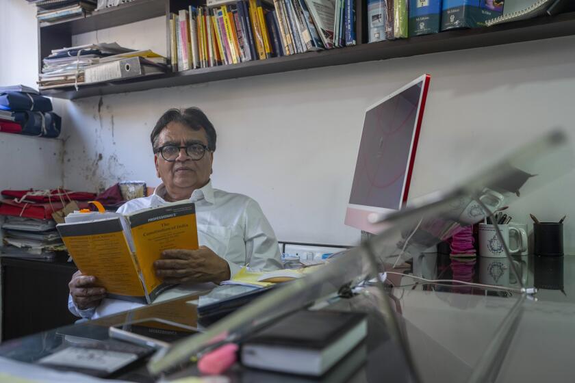 Lawyer Mihir Desai poses for a photograph at his office in Mumbai, India, April 3, 2024. Desai is defending a dozen political activists, journalists and lawyers jailed in 2018 on accusations of plotting to overthrow the Modi government. (AP Photo/Rafiq Maqbool)