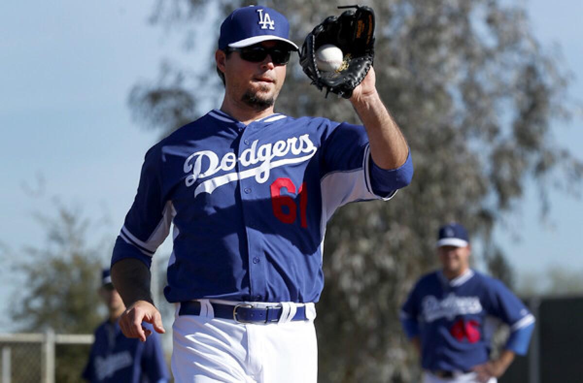 Dodgers pitcher Josh Beckett fields a toss at first base during a spring training workout last month at Camelback Ranch in Glendale, Ariz.