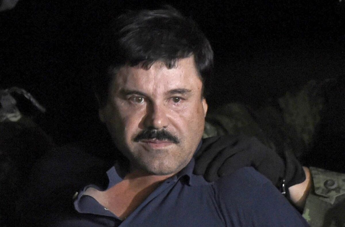 This file photo taken on January 08, 2016, shows drug kingpin Joaquin "El Chapo" Guzman escorted into a helicopter at Mexico City's airport following his recapture during an intense military operation in Los Mochis, in Sinaloa State.