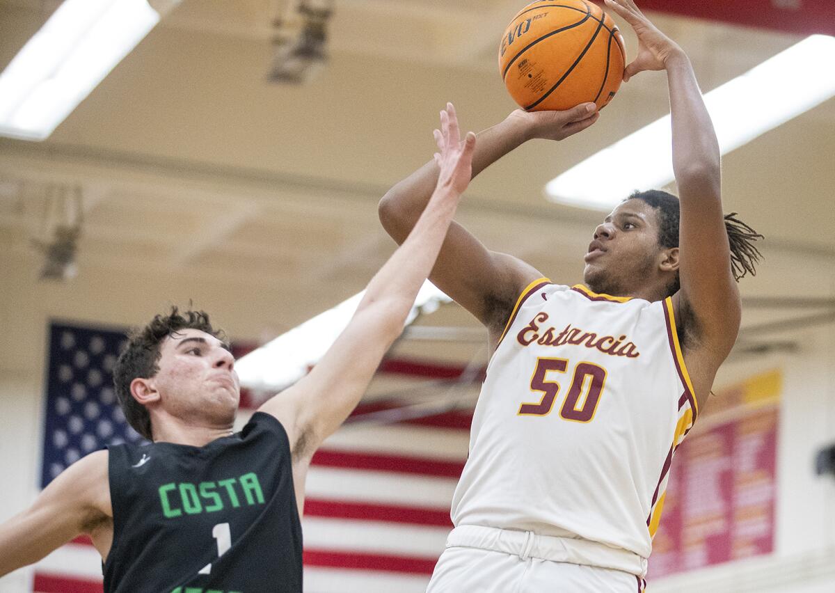 Estancia's Lewis Tate takes a shot over Costa Mesa's Dylan Matian during the first Battle for the Bell game on Monday.