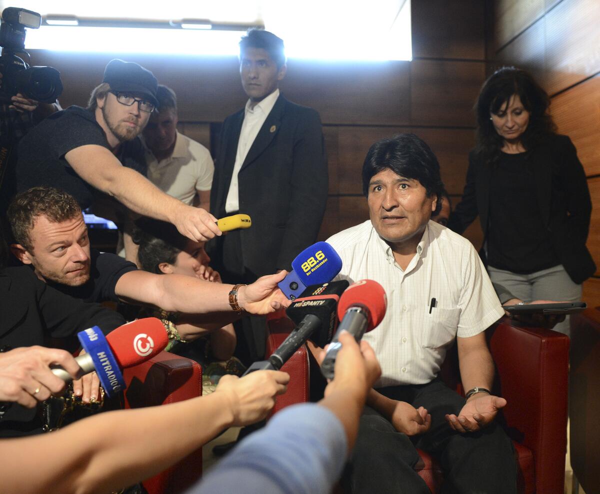 Bolivian President Evo Morales talks to journalists Wednesday at Vienna International Airport after his plane from Russia was forced to land there amid suspicion that fugitive that U.S. intelligence leaker Edward Snowden was on board.