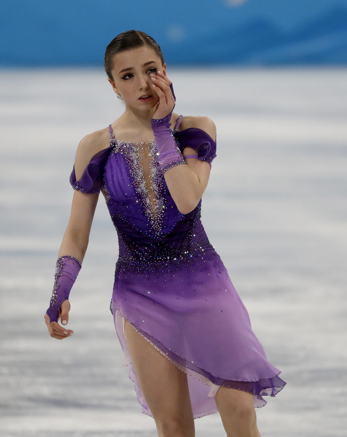 Kamila Valieva wipes her eyes at the 2022 Olympics.