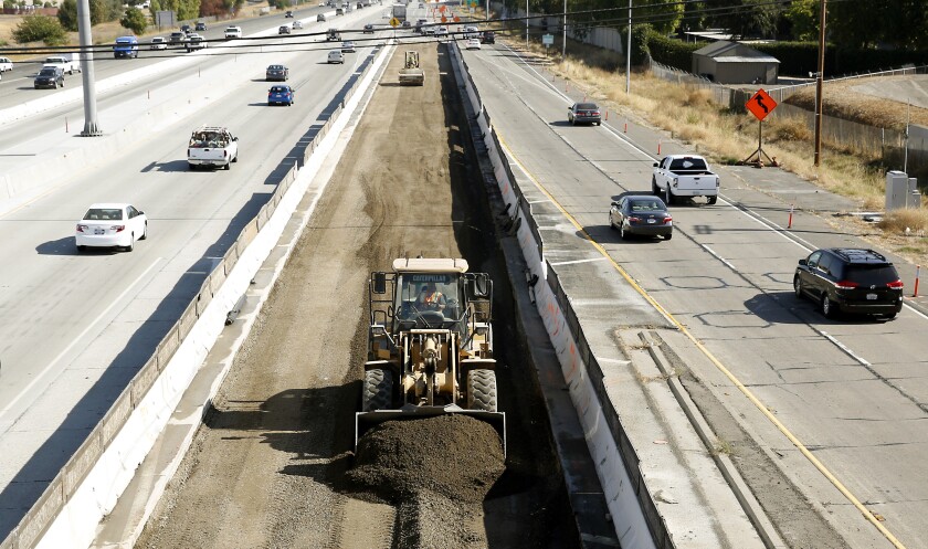 FILE - In this Oct. 15, 2015, file photo, vehicles pass a highway construction site near Sacramento, Calif. A former California Department of Transportation contract manager has pleaded guilty in what federal prosecutors say is an ongoing investigation in to a bid rigging and bribery scam. Choon Foo "Keith" Yong agreed Monday, April 11, 2022, to cooperate with an investigation into what prosecutors say was a conspiracy to rig the competitive bidding process for improvements and repair contracts. (AP Photo/Rich Pedroncelli, File)