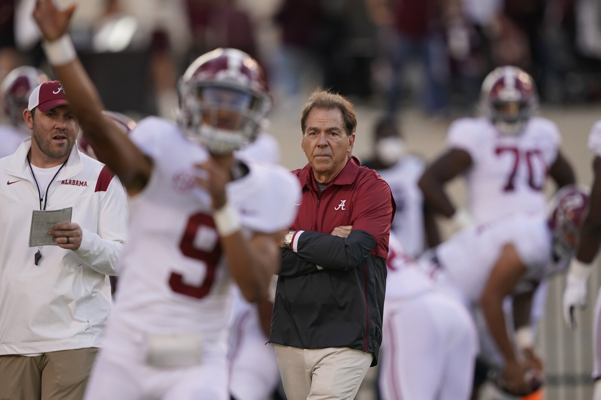 Alabama coach Nick Saban watches quarterback Bryce Young warm up before a game against Mississippi State in October.