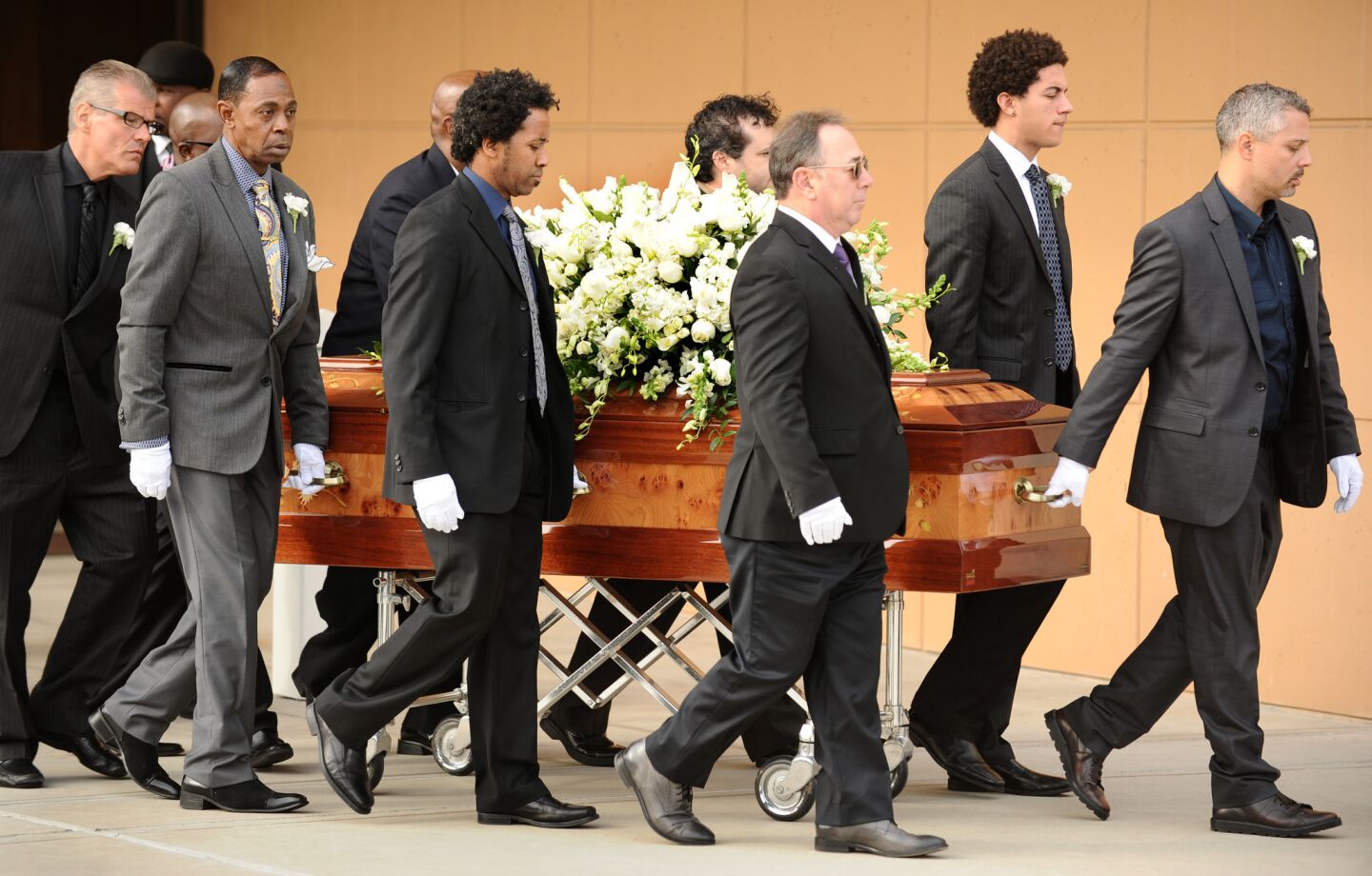 The casket of singer Natalie Cole is carried out of the church.