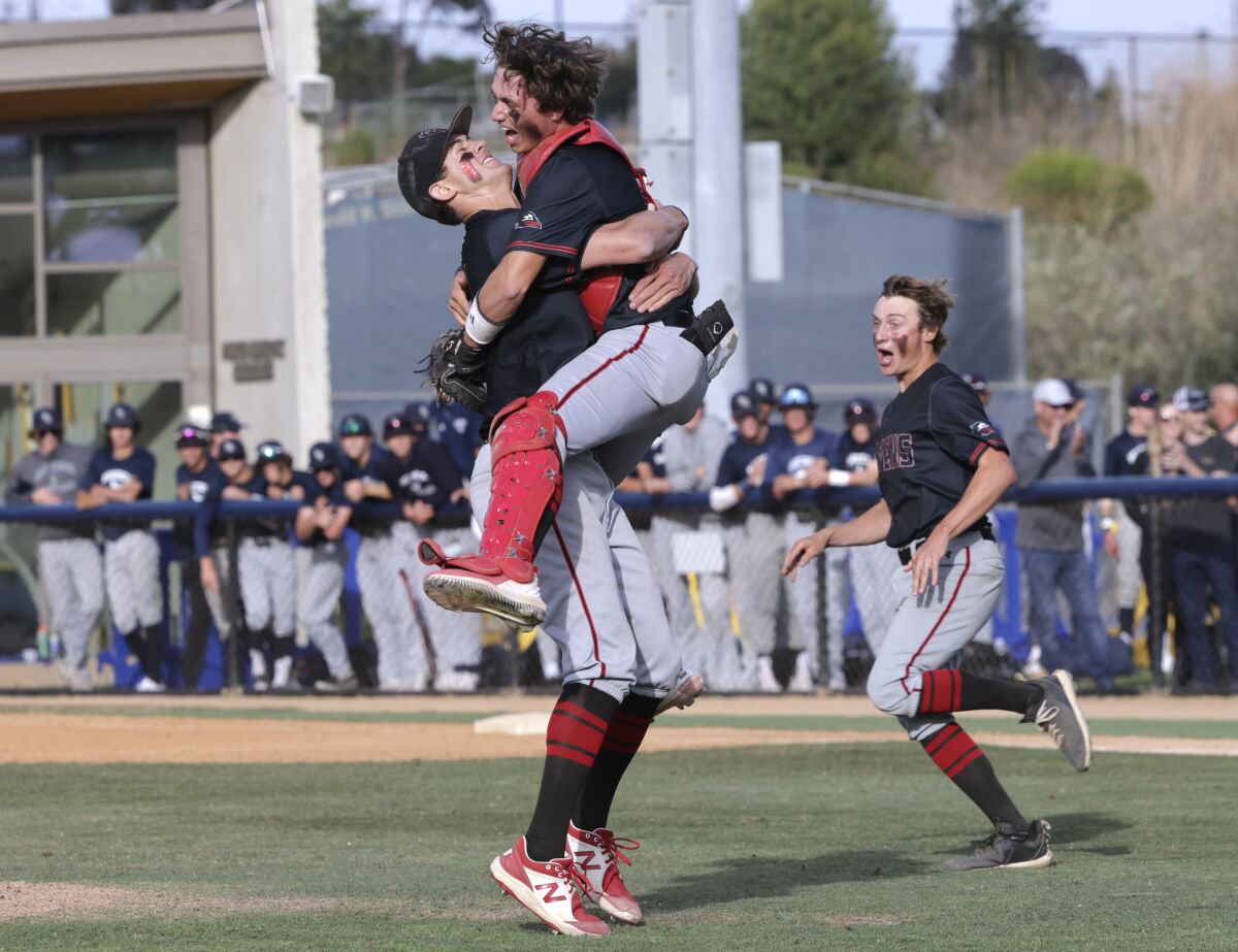 Canyon Crest Academy's catcher Ethan Swidler jumps into the arms of pitcher Sam Garewal after winning Division II title.
